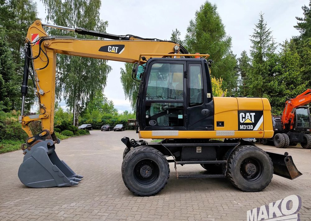 Caterpillar M313D - حفارة على عجلات: صور 1 Caterpillar M313D - حفارة على عجلات: صور 1