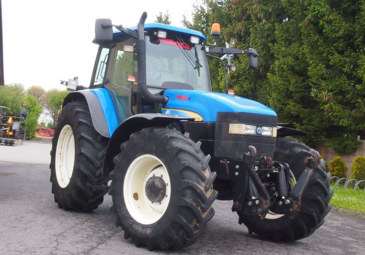 Ciągnik New Holland TM 140 2004 Przedni TUZ - جرار: صور 2 Ciągnik New Holland TM 140 2004 Przedni TUZ - جرار: صور 2